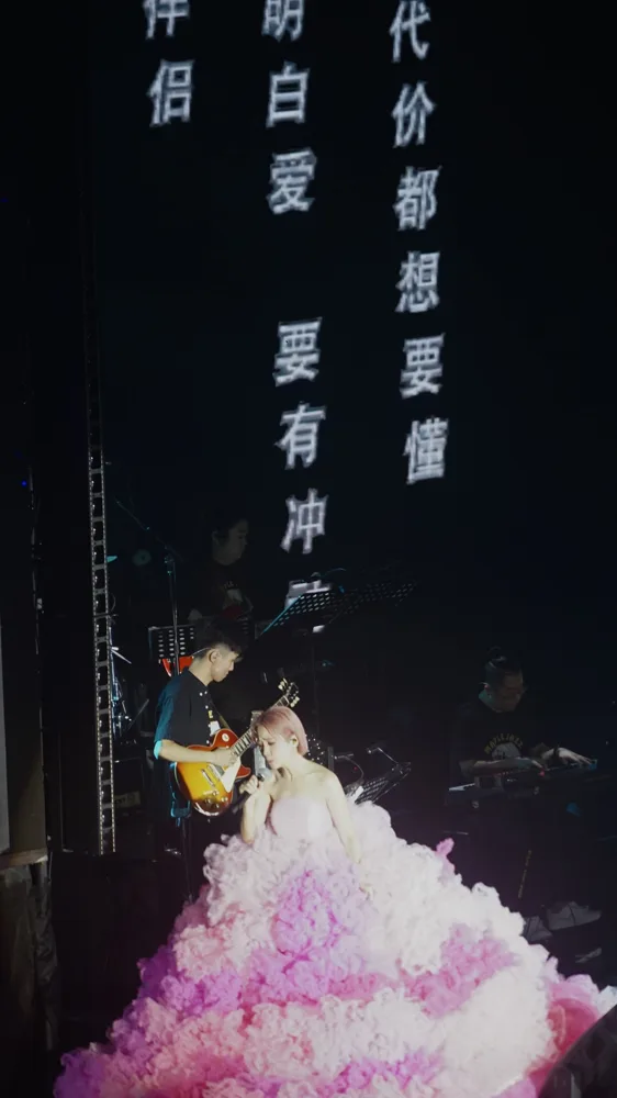 Side view of a singer with electric guitar and keyboard accompaniment