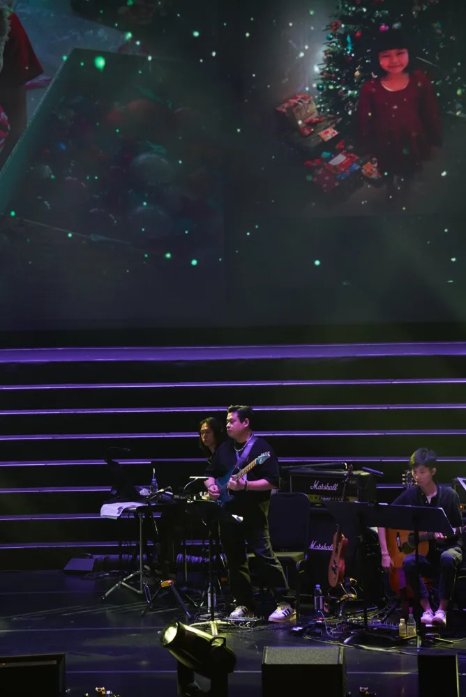 Electric and acoustic guitarists performing with the band